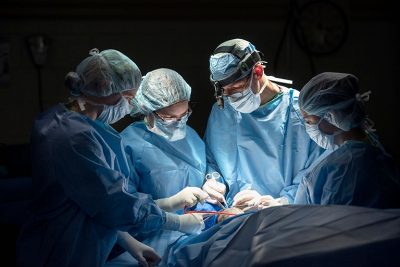 Surgery team members perform a procedure