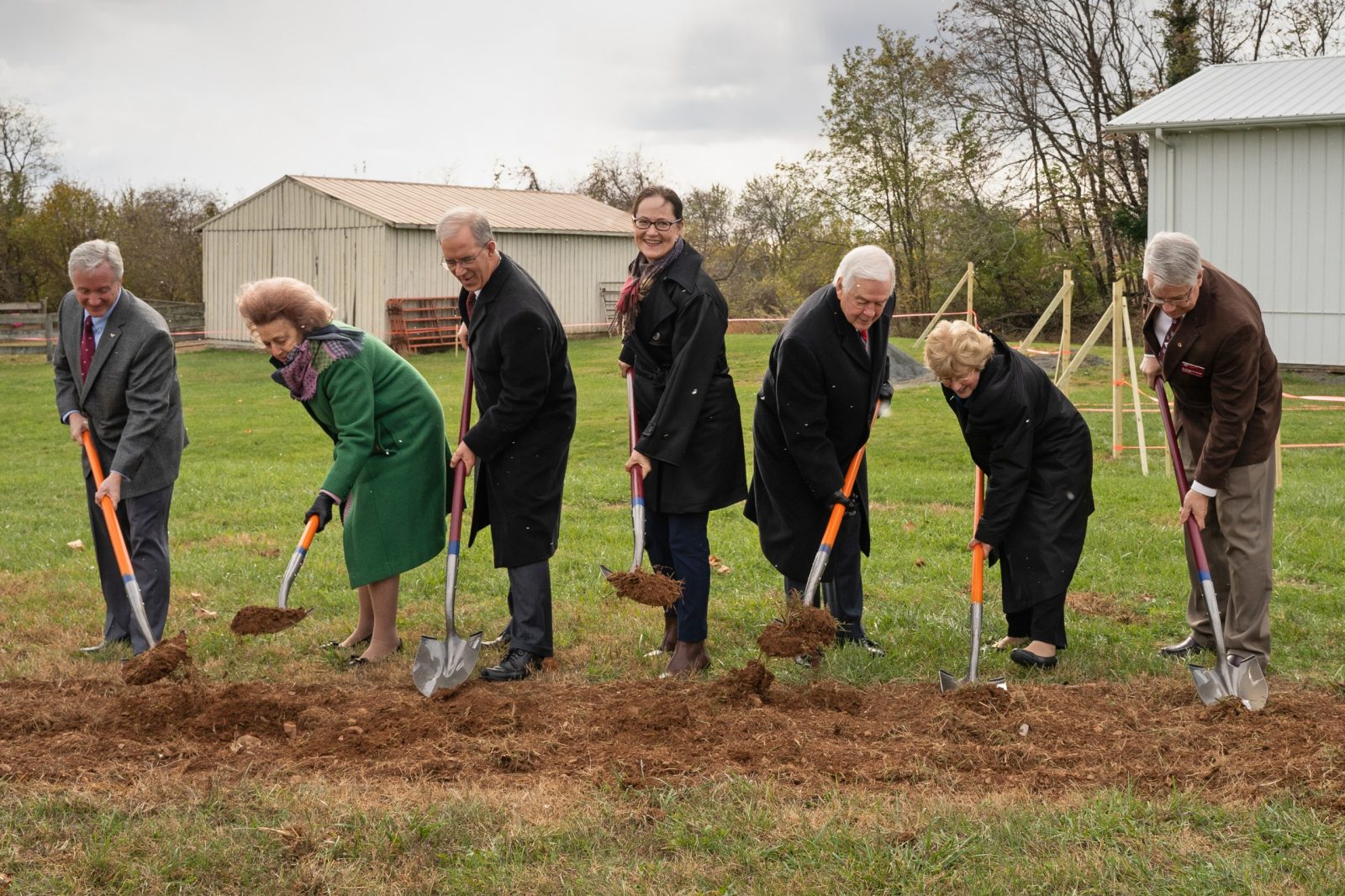 From left, Michael Erskine, Beverly "Peggy" Steinman, Frank Batten, Aimee Batten, Joe May, Bobby May, and Gregory B. Daniel break ground for the Steven and Jane Hale Indoor Arena. Photo by Devon Rowland for Virginia Tech.