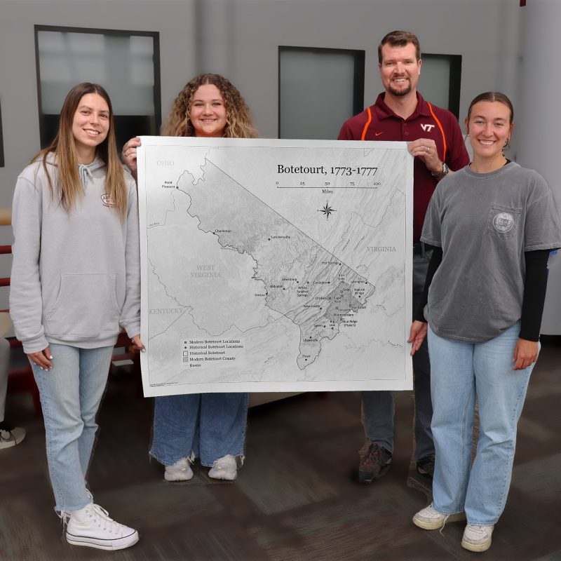 Hannah Crook (far left), Emma Dilic (middle left), and Sarah Cohoon (far right) are undergraduate teaching assistants in Senior Instructor Stewart Scales' (middle right) cartography class. When the Botetourt County Historical Society needed a map of the county in 1775, the TAs were tasked with its creation. It was presented to the society in March.