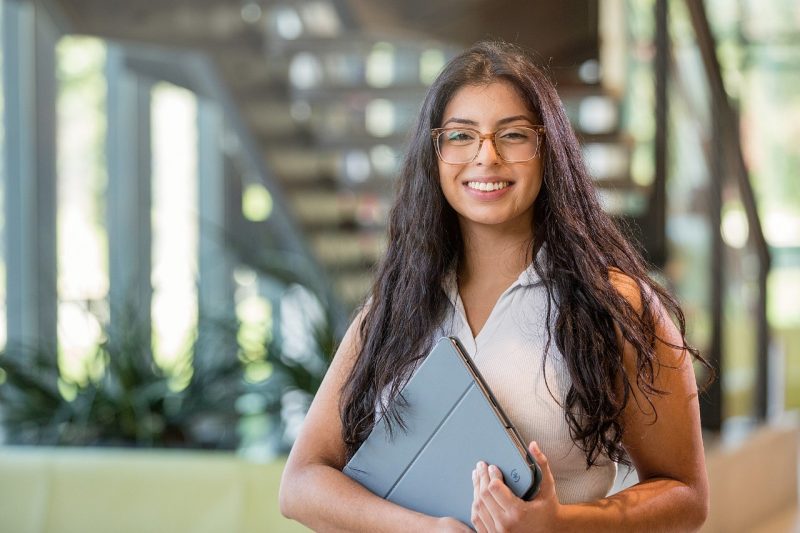 Woman holding a laptop computer.