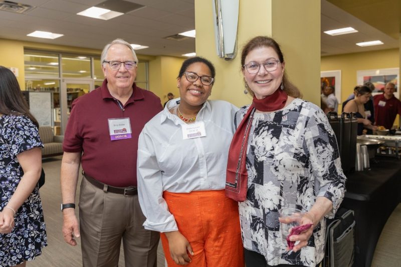 Jerry Archer, Ember Lucier, and KT Archer posing for a photo at Evening of Gratitude.